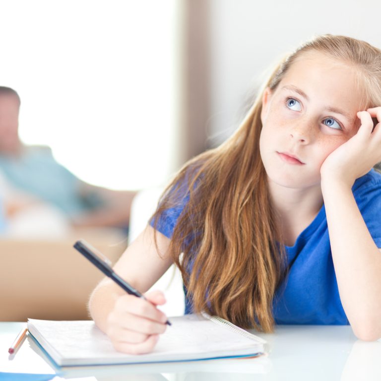 Young girl at home thinking about her schoolwork.
