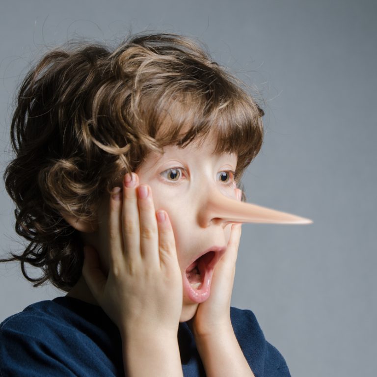 Headshot of real little boy getting his nose longer like pinocchio and acting surprised