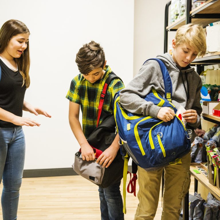 Four children shoplifting in a supermarket.
